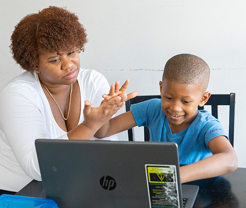 mom and son studying with computer