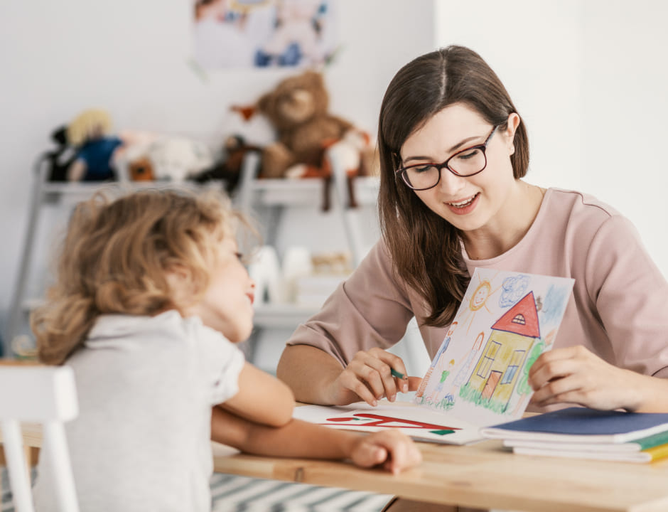 teacher showing a drawing to a girl