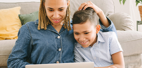 Mother and son doing homework with their laptop