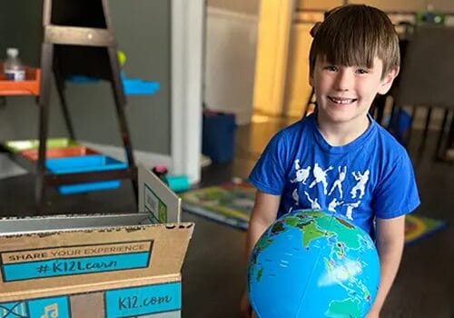 Little student with an earth globe