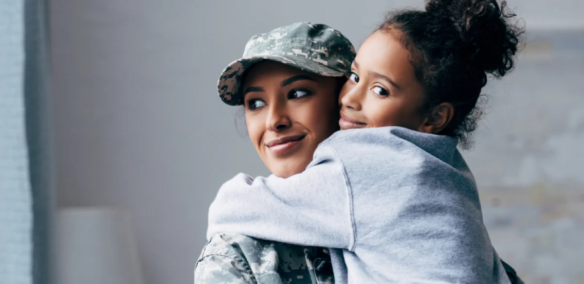 military woman with little girl